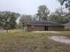 A beautiful backyard with a concrete patio and a large grassy area, perfect for outdoor activities and entertainment at 3752 Se 130Th St, Belleview, FL 34420