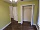 An empty bedroom with fresh paint and flooring featuring an open closet with hanging storage and a large window at 3752 Se 130Th St, Belleview, FL 34420