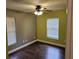 Bedroom with two windows and dark wood floors at 3752 Se 130Th St, Belleview, FL 34420