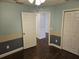 Bedroom with dark wood floors and access to another room at 3752 Se 130Th St, Belleview, FL 34420
