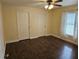 Bedroom features neutral walls, laminate flooring, and a ceiling fan at 3752 Se 130Th St, Belleview, FL 34420