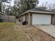 Side view of a large, attached two-car garage with an automatic door, next to a fenced yard at 3752 Se 130Th St, Belleview, FL 34420