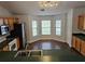 Eat-in kitchen with wood cabinets, stainless steel appliances, and a breakfast nook area with large windows at 3752 Se 130Th St, Belleview, FL 34420