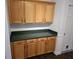 Kitchen featuring wood cabinets and dark countertops at 3752 Se 130Th St, Belleview, FL 34420