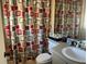 Bathroom with shower/tub combo and patterned curtain at 3915 Sw 139Th Street Rd, Ocala, FL 34473