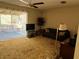 Living room with carpeting, window and patio access at 3915 Sw 139Th Street Rd, Ocala, FL 34473