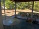 Screened porch with table and chairs at 3915 Sw 139Th Street Rd, Ocala, FL 34473