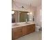 Bathroom boasts double sinks, wood cabinets, and a shower at 4960 Se 17Th St, Ocala, FL 34471