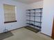 Simple bedroom with window, beige carpet, and shelving at 4960 Se 17Th St, Ocala, FL 34471
