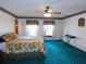 Bright bedroom with floral bedding and teal carpet at 4960 Se 17Th St, Ocala, FL 34471