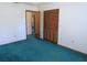 Spacious bedroom with teal carpet and two closets at 4960 Se 17Th St, Ocala, FL 34471