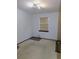 Bedroom with beige carpet, window, and wall shelving at 4960 Se 17Th St, Ocala, FL 34471