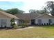 Single-story home with a spacious lawn and mature trees at 4960 Se 17Th St, Ocala, FL 34471