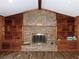Brick fireplace with wood mantel and built-in shelving at 4960 Se 17Th St, Ocala, FL 34471