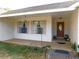 Covered porch with double windows and a wooden door at 4960 Se 17Th St, Ocala, FL 34471