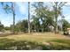 Large front yard with tall trees and green grass at 4960 Se 17Th St, Ocala, FL 34471