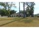 One-story house with a large front yard and trees at 4960 Se 17Th St, Ocala, FL 34471