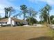 Single-story home with a circular driveway and trees at 4960 Se 17Th St, Ocala, FL 34471