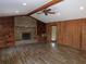 Spacious living room with brick fireplace, built-in shelving, and wood paneling at 4960 Se 17Th St, Ocala, FL 34471