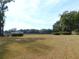 Open pasture with a wooden fence and trees at 4960 Se 17Th St, Ocala, FL 34471
