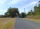 Long paved road with trees and open fields at 4960 Se 17Th St, Ocala, FL 34471