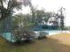 Private tennis court with surrounding trees at 4960 Se 17Th St, Ocala, FL 34471