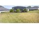 Large backyard with a screened pool and tropical landscaping at 5141 Greens Dr, Lady Lake, FL 32159