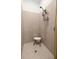 Simple bathroom with shower and a shower chair at 5141 Greens Dr, Lady Lake, FL 32159