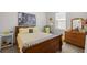 Cozy bedroom with a wooden sleigh bed and vintage dresser at 5141 Greens Dr, Lady Lake, FL 32159