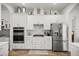 Bright kitchen with stainless steel appliances and white cabinets at 5141 Greens Dr, Lady Lake, FL 32159