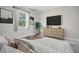 Bedroom with dresser and large bed, TV included at 5789 Sw 129Th Place Rd, Ocala, FL 34473