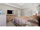 Bright bedroom featuring a king-size bed and a large TV at 6303 Sw 116Th Street Rd, Ocala, FL 34476