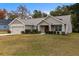 Single-story house with two-car garage and lawn at 6303 Sw 116Th Street Rd, Ocala, FL 34476