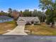 Single-story house with two-car garage and lawn at 6303 Sw 116Th Street Rd, Ocala, FL 34476