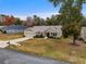 Tan one-story house with attached garage and landscaping at 6303 Sw 116Th Street Rd, Ocala, FL 34476