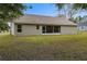 Back of house with screened porch and yard at 6303 Sw 116Th Street Rd, Ocala, FL 34476