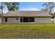 Back of house with screened porch and yard at 6303 Sw 116Th Street Rd, Ocala, FL 34476