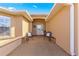 Covered entryway with two wicker chairs and a view of the backyard at 8125 Sw 81St Loop, Ocala, FL 34476