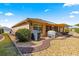 Rear house view, showcasing patio, grill and landscaping at 8125 Sw 81St Loop, Ocala, FL 34476