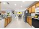 Open concept kitchen with stainless steel appliances and breakfast nook at 8125 Sw 81St Loop, Ocala, FL 34476