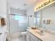 Bright bathroom with white cabinets, marble countertops, and a shower-tub combination at 8574 Sw 60Th Ct, Ocala, FL 34476
