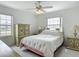 Bright bedroom with light walls, ceiling fan, carpeted floor, and views from two windows at 8574 Sw 60Th Ct, Ocala, FL 34476