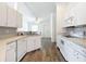 Kitchen with white cabinets, an island, and a view of the dining area at 8574 Sw 60Th Ct, Ocala, FL 34476