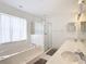 Bright bathroom featuring a garden tub, shower, and double vanity at 8574 Sw 60Th Ct, Ocala, FL 34476