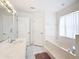 Bright bathroom featuring a soaking tub, vanity, and tiled floor at 8574 Sw 60Th Ct, Ocala, FL 34476