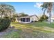 Well-kept backyard featuring a screened-in porch, mature trees, and landscaped surroundings at 8648 Sw 95Th Ln # A, Ocala, FL 34481