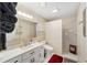 Bright bathroom featuring white vanity, enclosed shower, and decorative mirror at 8648 Sw 95Th Ln # A, Ocala, FL 34481