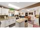 Bright kitchen with granite countertops, white cabinetry, and eat-in island at 8648 Sw 95Th Ln # A, Ocala, FL 34481
