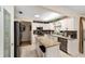 Open kitchen design featuring stainless appliances and center island with seating at 8648 Sw 95Th Ln # A, Ocala, FL 34481
