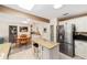 Kitchen with island seating, stainless refrigerator, and view to dining area at 8648 Sw 95Th Ln # A, Ocala, FL 34481